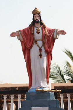 A statue of jesus on top of a building