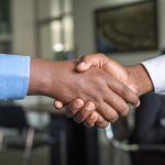 Two Person in Long-sleeved Shirt Shakehand